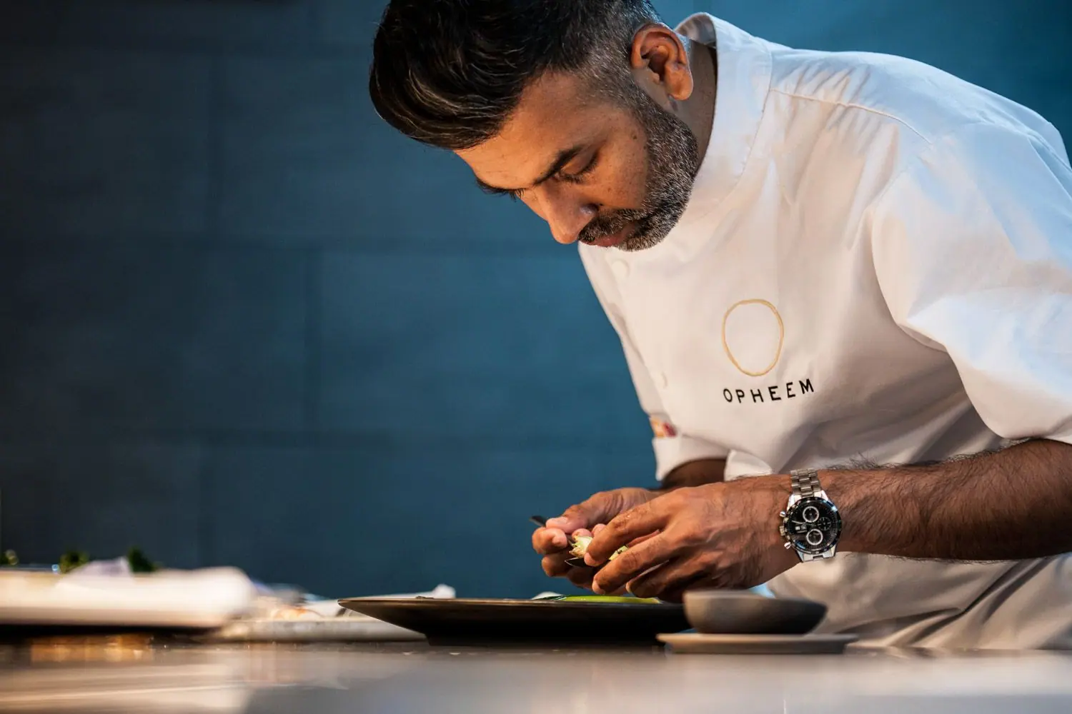 Aktar Islam leaning in to finish a plate